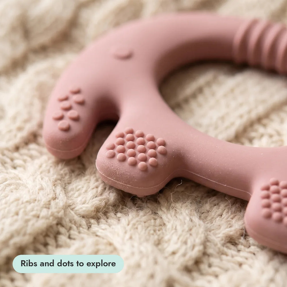 Close-up of a Complete Teething Gift Box teether texture on a knitted blanket