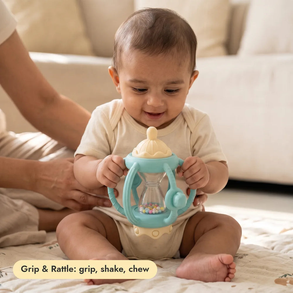 Baby with the 3-in-1 Grip & Rattle Teether from the Complete Teething Gift Box