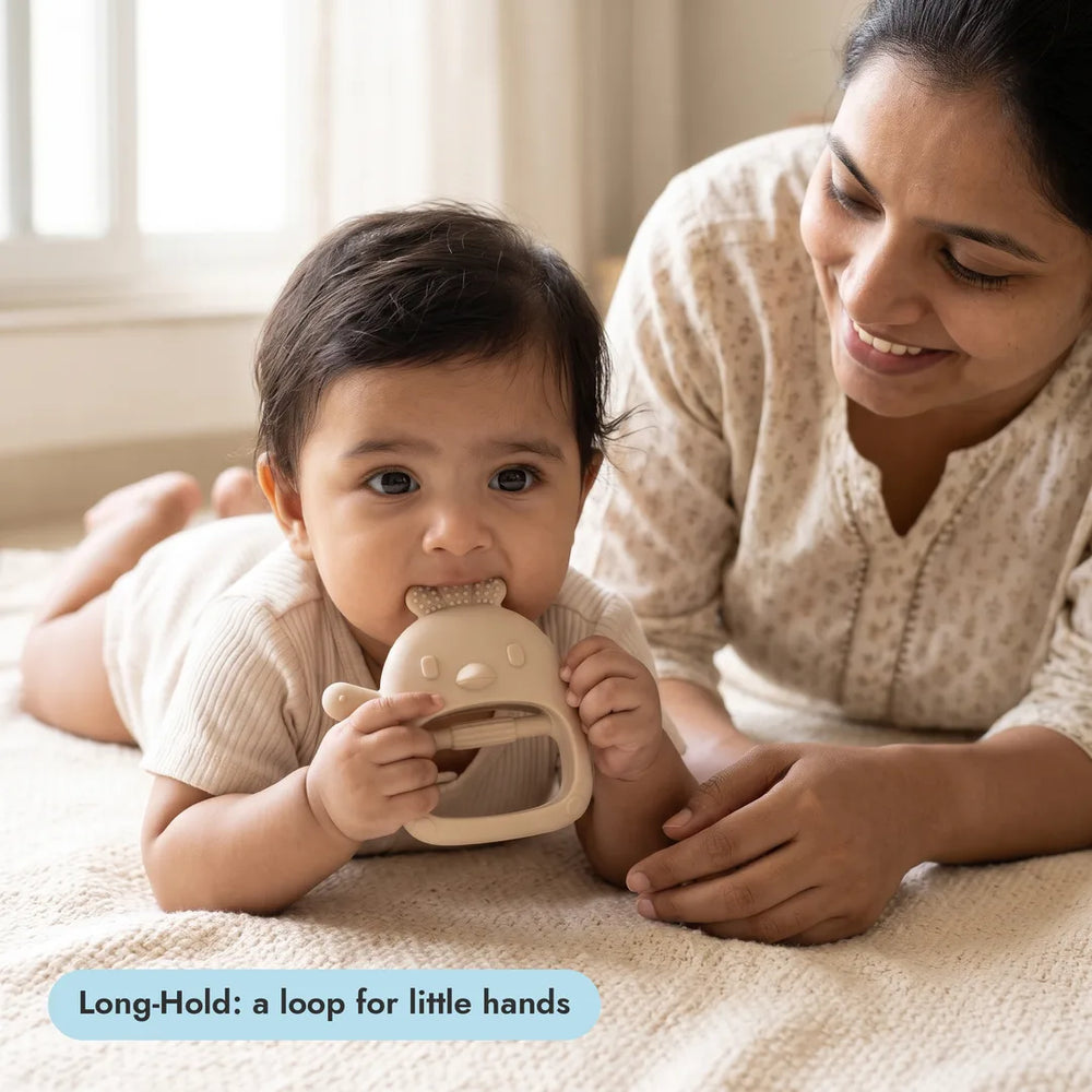 Baby with the Long-Hold Handle Teether from the Complete Teething Gift Box