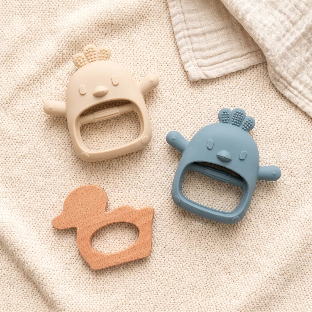 Long-Hold Twin Pack + Wooden teethers laid out on a knitted blanket