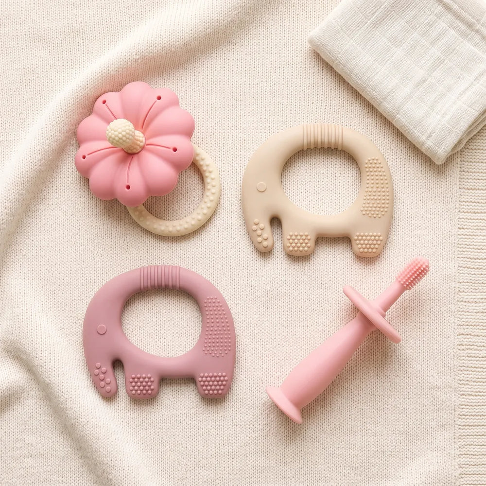 Texture Explorer Trio teethers laid out on a knitted blanket