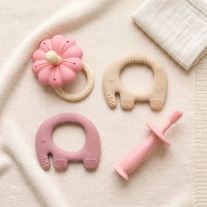 Texture Explorer Trio teethers laid out on a knitted blanket